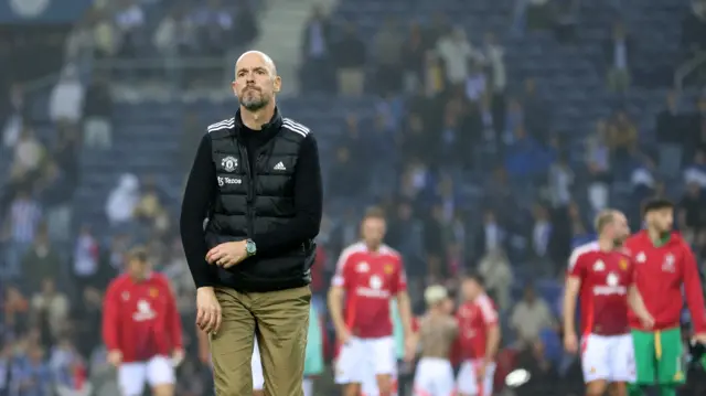 Erik ten Hag looks on after match on pitch