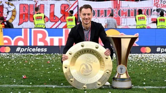 Matthias Jaissle poses with championship trophy and the Austrian Soccer Cup in 2022 when managing Red Bull Salzburg 