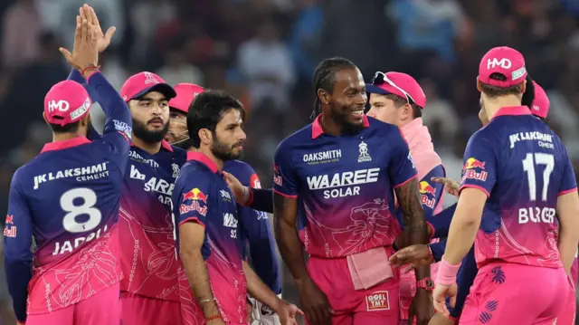 Ravi Bishnoi celebrates a wicket with Jofra Archer and the rest of his team-mates from Rajasthan Royals 
