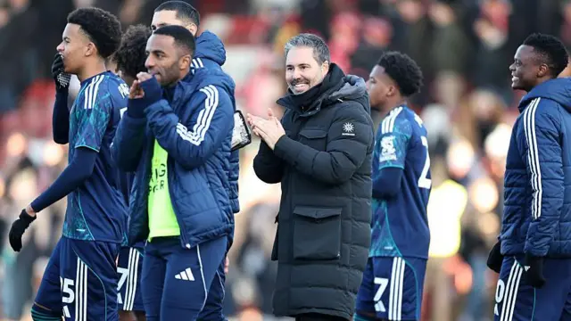 Leicester City boss Marti Cifuentes among his players as they celebrate their FA Cup third-round win at Cheltenham