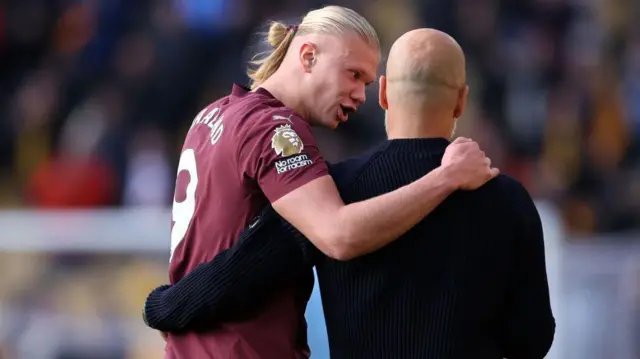 Pep Guardiola the manager of Manchester City talks with Erling Haaland after the Premier League match between Wolverhampton Wanderers FC and Manchester City FC at Molineux 