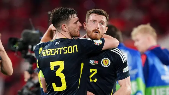 Scotland captain Andy Robertson embraces Anthony Ralston at full-time