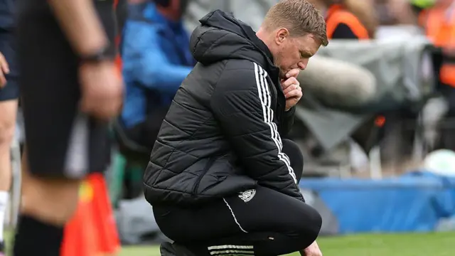 Eddie Howe looks frustrated and looks at the ground