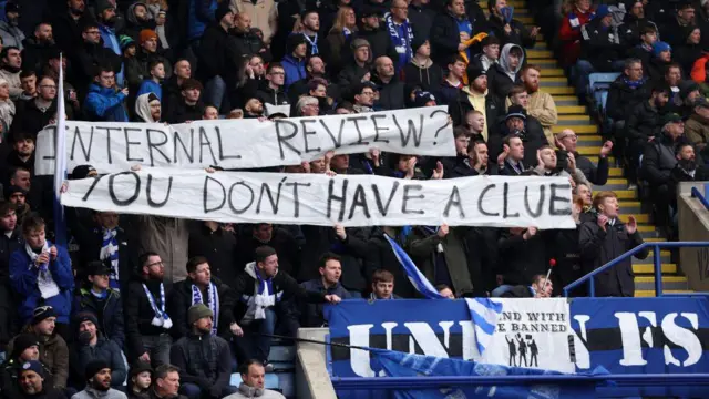 Leicester fans hold up banner that says 'Internal review? You don't have a clue' in protest against club hierarchy 