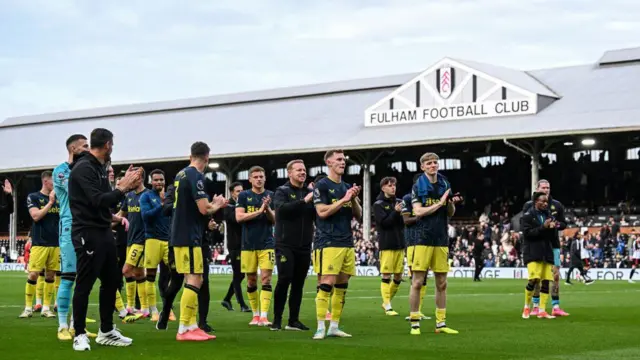 Newcastle United Players and Staff clap the away fans after winning the Premier League match between Fulham FC and Newcastle United at Craven Cottage