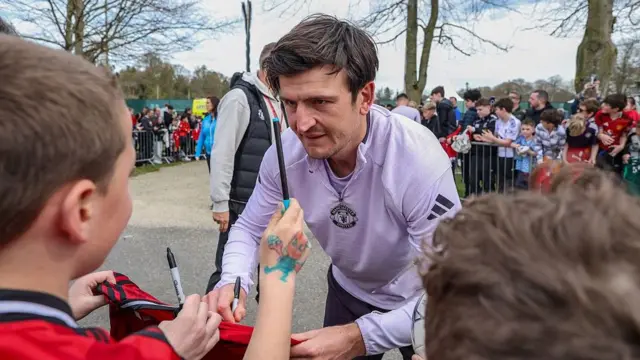 Manchester United defender Harry Maguire signs autographs and poses for pictures with fans