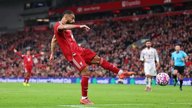Mohamed Salah takes a shot for Liverpool against Manchester United