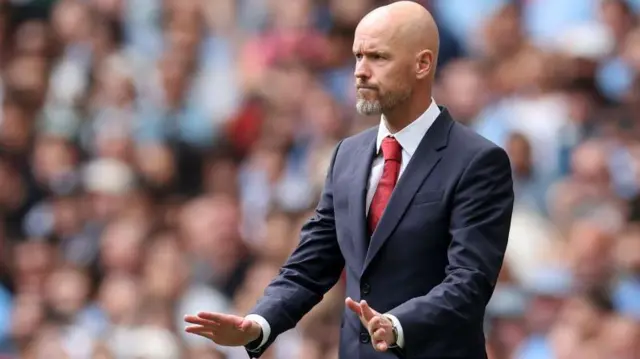 Erik ten Hag stands on the touchline