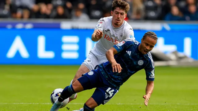 Josh Key of Swansea City battles for the ball with Bobby De Cordova-Reid of Leicester City