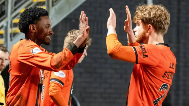 Dundee United's Amar Fatah (L) celebrates scoring a penalty to make it 2-1 with Luca Stephenson 