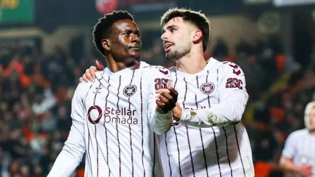 Pierre Landry Kabore and Claudio Braga (right) celebrate at Tannadice