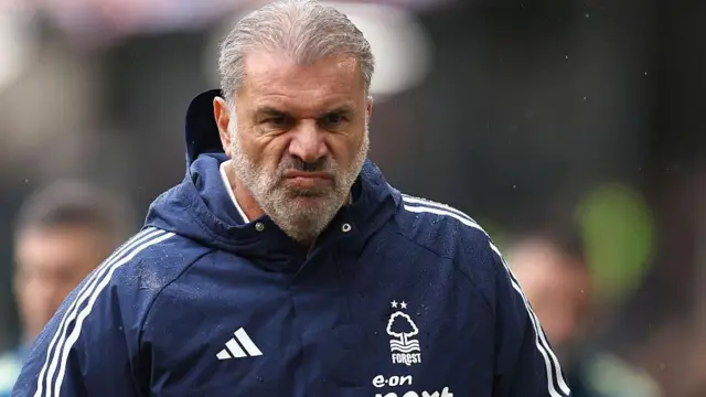 Ange Postecoglou walks in a Nottingham Forest coat