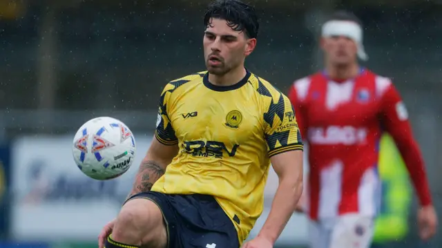 Callum Dolan juggles the ball on his right knee in a match for Torquay United