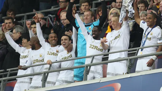 Swansea players lift the League Cup in 2014