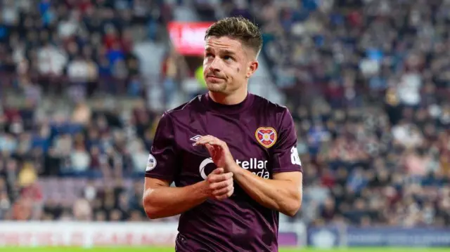 Hearts' Cameron Devlin applauds fans as he is substituted off during a UEFA Europa League playoff second leg match between Heart of Midlothian and Viktoria Plzen at Tynecastle Park, on August 29, 2024, in Edinburgh, Scotland. (Photo by Ross Parker / SNS Group)