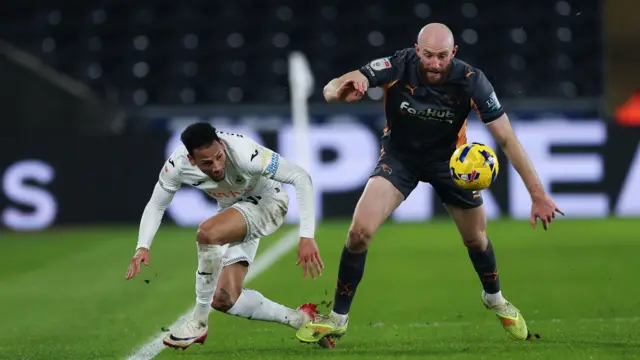 Ronald of Swansea City and Matt Clarke of Derby County compete for the ball