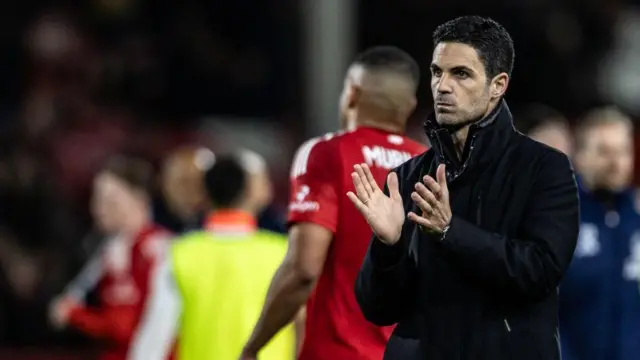 Arsenal's manager Mikel Arteta applauds his side's travelling supporters