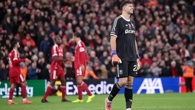Emiliano Martinez of Aston Villa looks dejected after his mistake leads to Liverpool's first goal