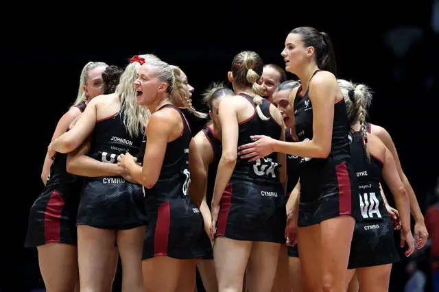Wales netball players in a huddle
