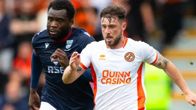 Ross County's Michee Efete and Dundee United's Will Ferry 