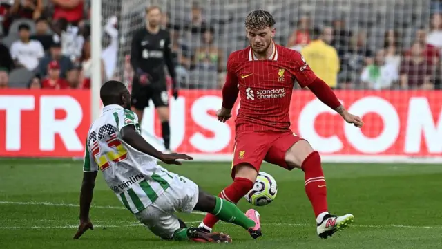 Harvey Elliott of Liverpool is challenged by Youssouf Sabaly of Real Betis