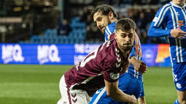 Claudio Braga goes past Robbie Deas