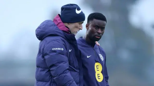 Thomas Tuchel talks to Marc Guehi during England training