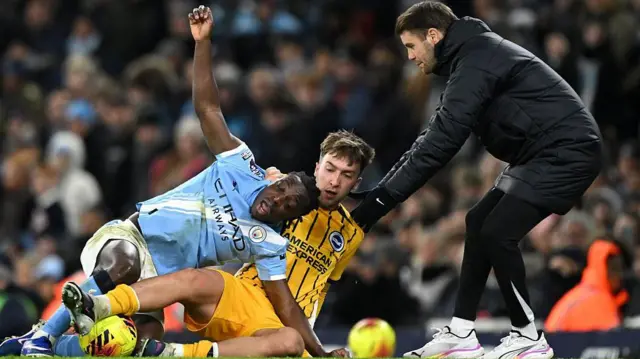 Jeremy Doku of Manchester City battles for possession with Jack Hinshelwood