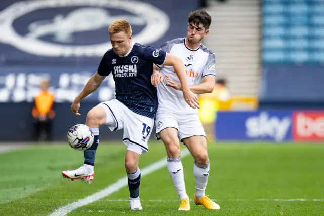 Millwall's Duncan Watmore competes with Swansea's Josh Key