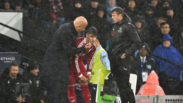 Liverpool head coach Arne Slot speaks with Milos Kerkez