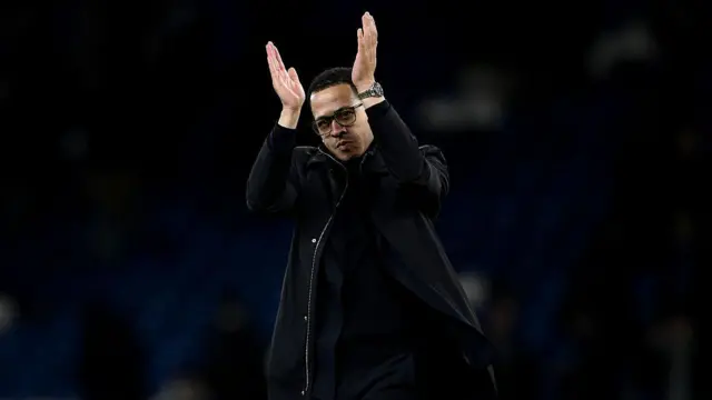 Liam Rosenior applauds Chelsea fans after the game.