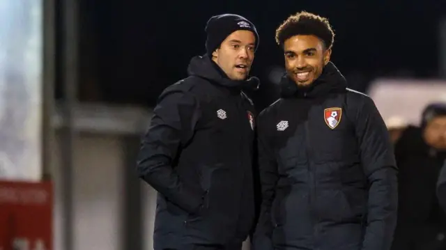 Junior Stanislas, on the right, stands on the touchline with Bournemough Under-18s head coach James Lowy during an FA Youth Cup tie