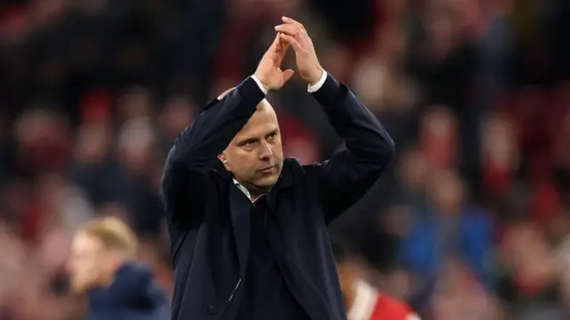 Arne Slot, Manager of Liverpool, applauds the fans after the team's victory in the Premier League match between Liverpool FC and Brighton & Hove Albion FC at Anfield