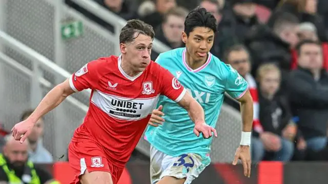 Middlesbrough's Callum Brittain takes on Oxford's Jin Woo Jeon