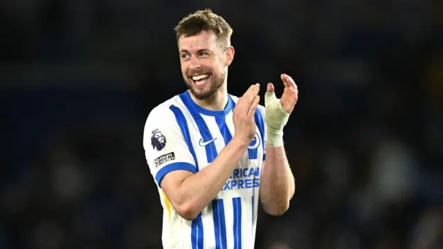 Adam Webster smiles as he acknowledges the Brighton fans