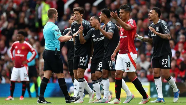 Aston Villa's Pau Torres, Youri Tielemans and Ollie Watkins protesting to referee Thomas Bramall