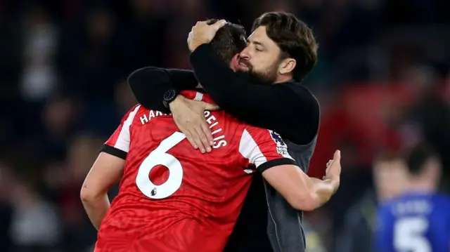 Russell Martin, Manager of Southampton, interacts with Taylor Harwood-Bellis of Southampton after the Premier League match between Southampton FC and Everton FC at St Mary's Stadium