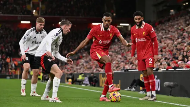 Ryan Gravenberch of Liverpool is challenged by Emile Smith Rowe of Fulham during the Premier League match between Liverpool FC and Fulham FC at Anfield