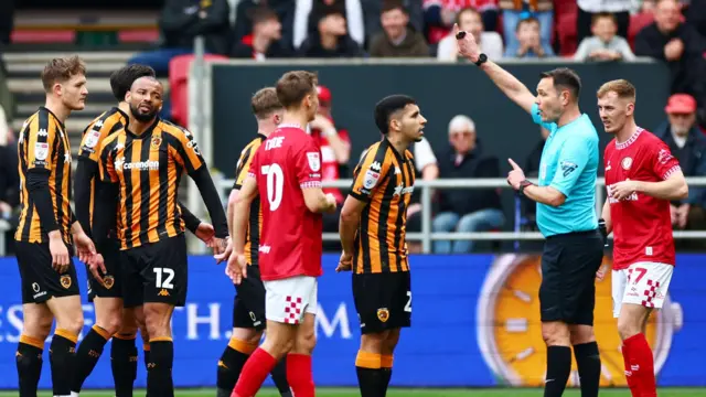 Hull City's Joao Pedro (No 12) gets sent off by referee James Linington for his challenge on George Tanner