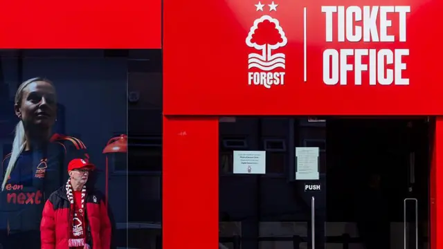 A fan stands alone outside the Nottingham Forest ticket office