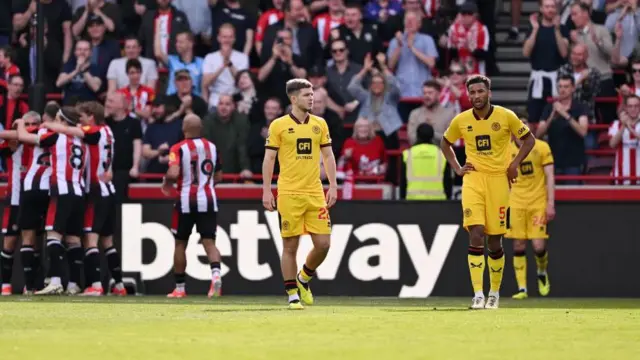 Sheffield United players react after Brentford goal