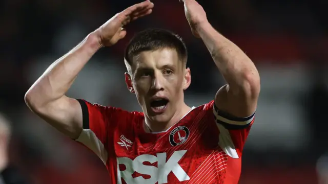 Charlton captain Greg Docherty lifts his arms in the air to applaud the home supporters after the 0-0 draw with QPR 
