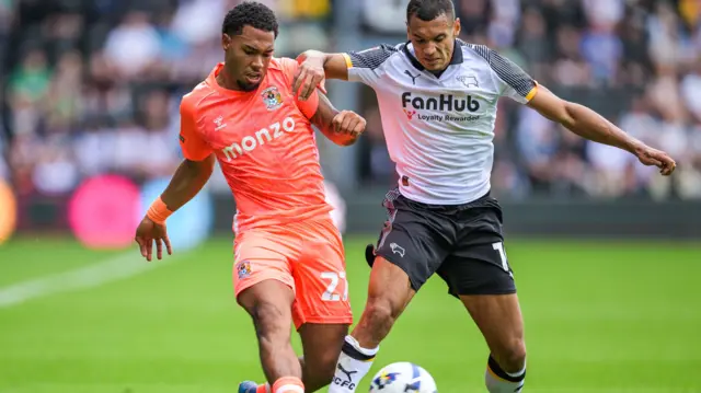 Milan van Ewijk of Coventry City and Kayden Jackson of Derby County
