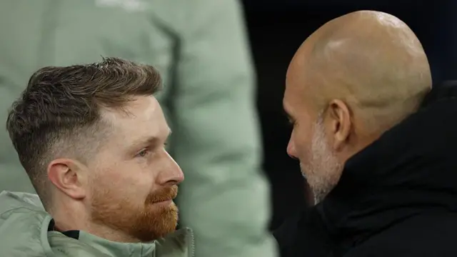 Calum McFarlane and Pep Guardiola share an embrace