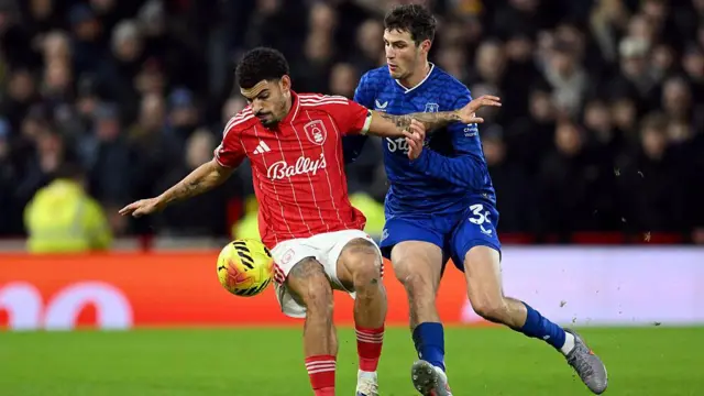 Gibbs-White shields the ball against an Everton player