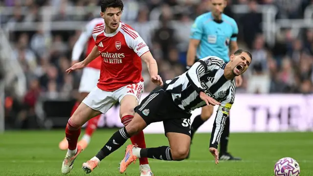 Declan Rice fouls Bruno Guimaraes