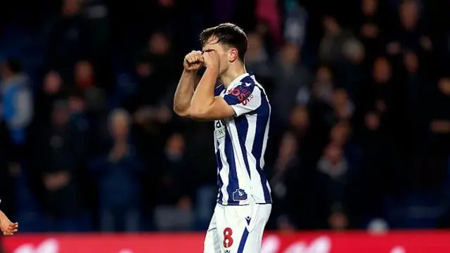Jayson Molumby of West Bromwich Albion makes a crying gesture as he celebrates after scoring the winner against Swansea