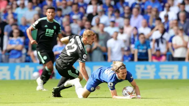 Conor Gallagher of Chelsea is brought down by Kiernan Dewsbury-Hall of Leicester City