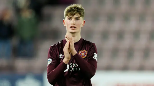 Hearts striker James Wilson applauds supporters