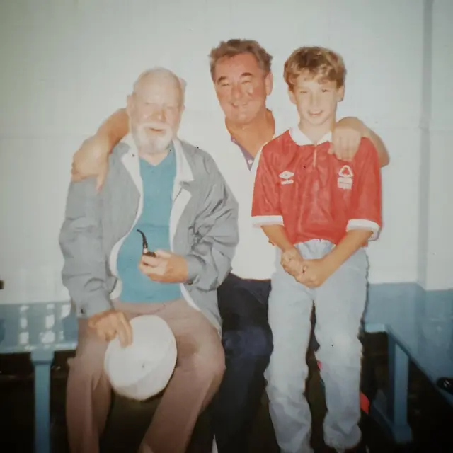 A picture of a grandad with a white beard, Brian Clough and a small boy in a Forest shirt